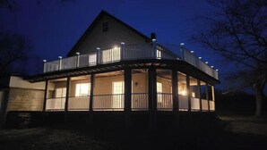 A two-story house with a balcony, a porch, and a garage. - Lakehouse Vineyard on Lake Erie! (Ripley)