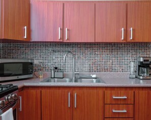 Enjoy cooking in this fully equipped kitchen with a gas stove, microwave, and coffee maker.