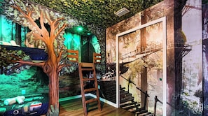 A room with a tree mural, a ladder, and a mural of a bridge. - 8BR Family Getaway | Private Pool & Game Room (Kissimmee)