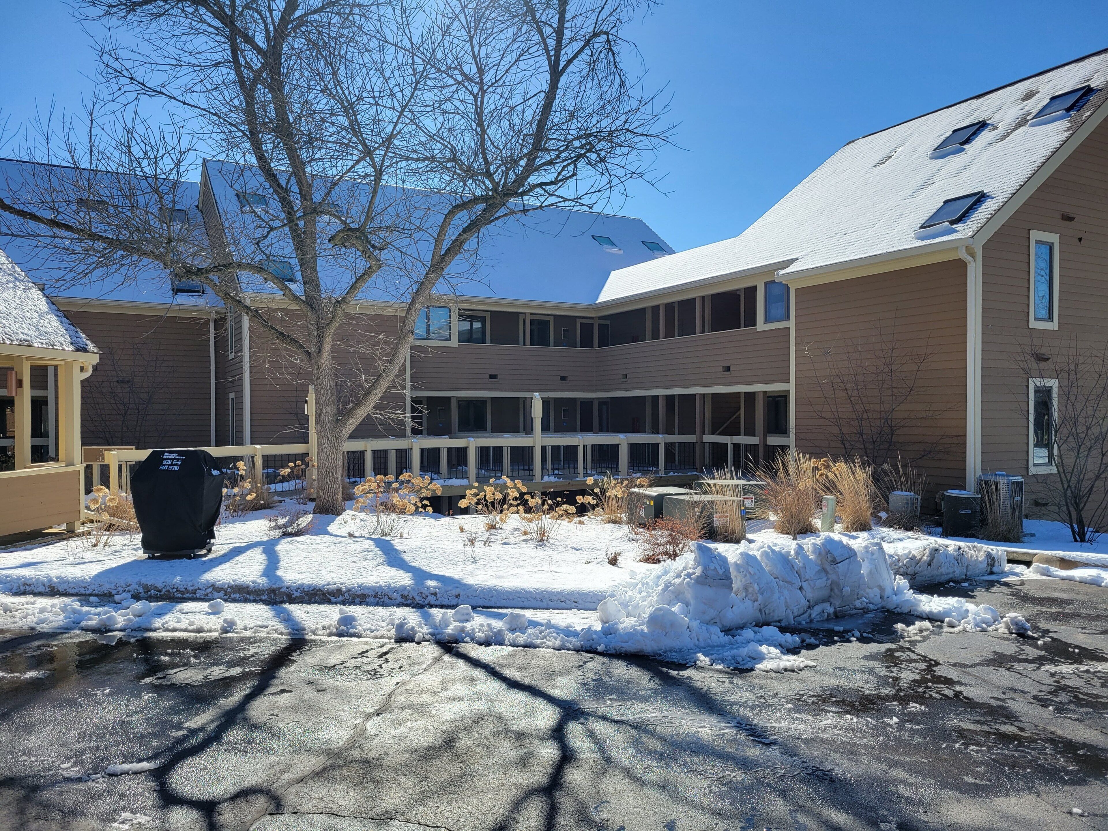A multi-story building with a flat roof and large windows.