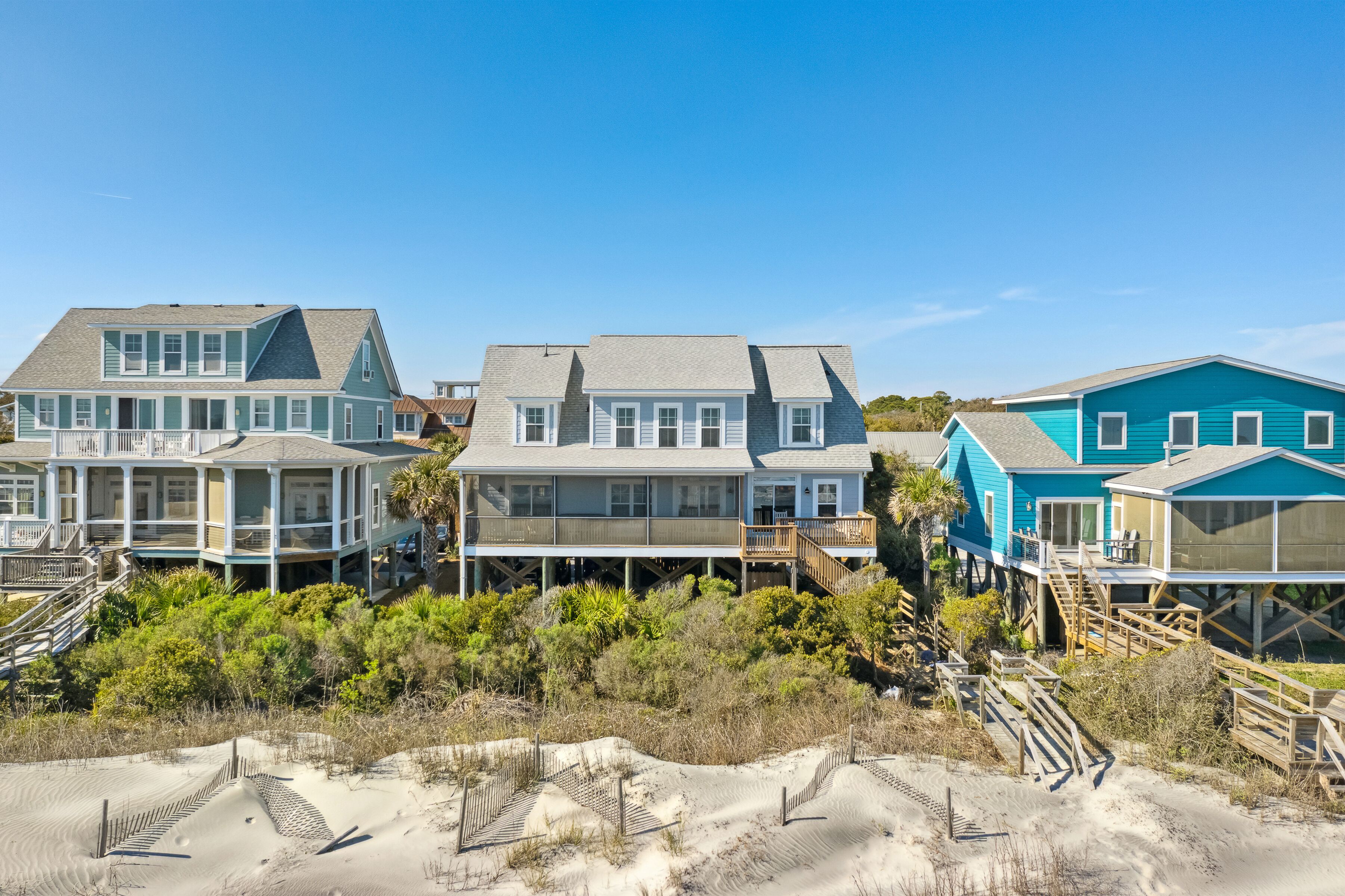 Beachfront houses with elevated decks, some with attached porches.
