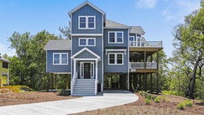 A two-story house with a covered porch and a balcony. - Sound Views, Hot Tub, Village at Ocean Hill, Community Pools (Corolla)
