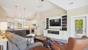 A modern living room with a sofa, coffee table, and leather chairs. - Sound Views, Hot Tub, Village at Ocean Hill, Community Pools (Corolla)
