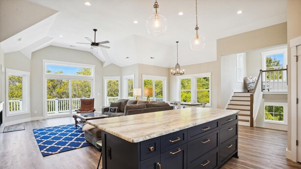 A spacious kitchen with a large island, dark cabinetry, and a ceiling fan. - Sound Views, Hot Tub, Village at Ocean Hill, Community Pools (Corolla)