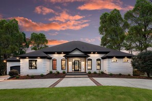 Stunning two-story house with a central entrance and manicured lawn.