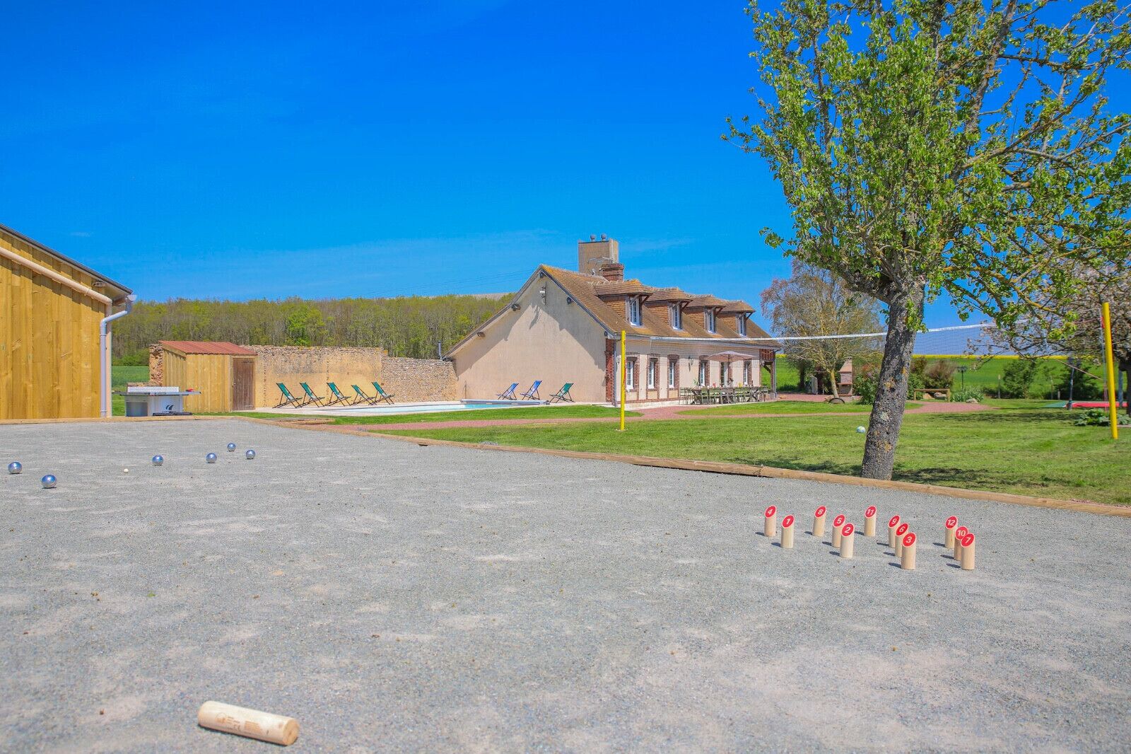 Ein Innenhof mit Billardtisch, Sitzgelegenheiten im Freien und einem Gebäude im Hintergrund.