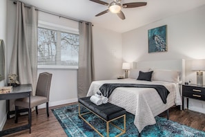 Experience a cozy and indulgent stay in our elegantly designed queen bed. The accompanying black desk, paired with a luxurious gold mirror, offers the ideal space work and getting ready.