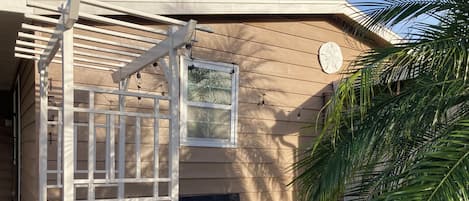 Un patio couvert aménagé avec du mobilier d’extérieur et une pergola.