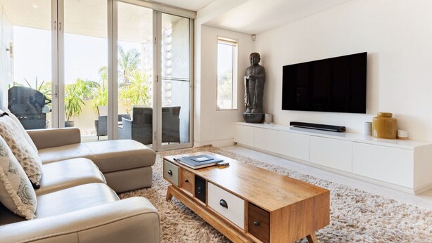 A modern living room with a sofa, coffee table, and TV. - Bellevue Hill Designer, Beaches, City & Views (Bellevue Hill)