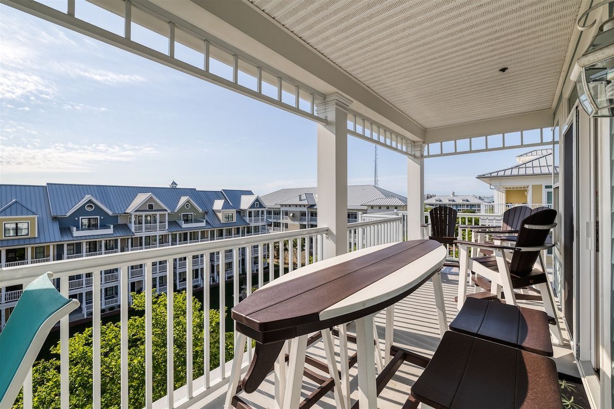 A covered outdoor area with a wooden deck, a table, and chairs.