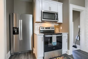 Fridge, coffee/tea maker, high chair, cookware/dishes/utensils