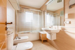 Enjoy a refreshing shower in the sleek bathroom with a large glass enclosure and standalone sink.