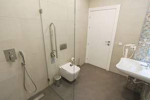 Bathroom features a glass shower enclosure, pedestal sink, and standard toilet.