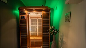 A wooden elevator with a control panel, a green-lit wall, and a framed inspirational quote. - In Heart of Stavanger BnB with Billiard & Sauna (Stavanger)