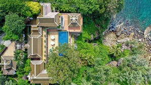 An aerial view of a coastal property with multiple buildings, a swimming pool, and lush greenery. - Villa Horizon (Kamala)