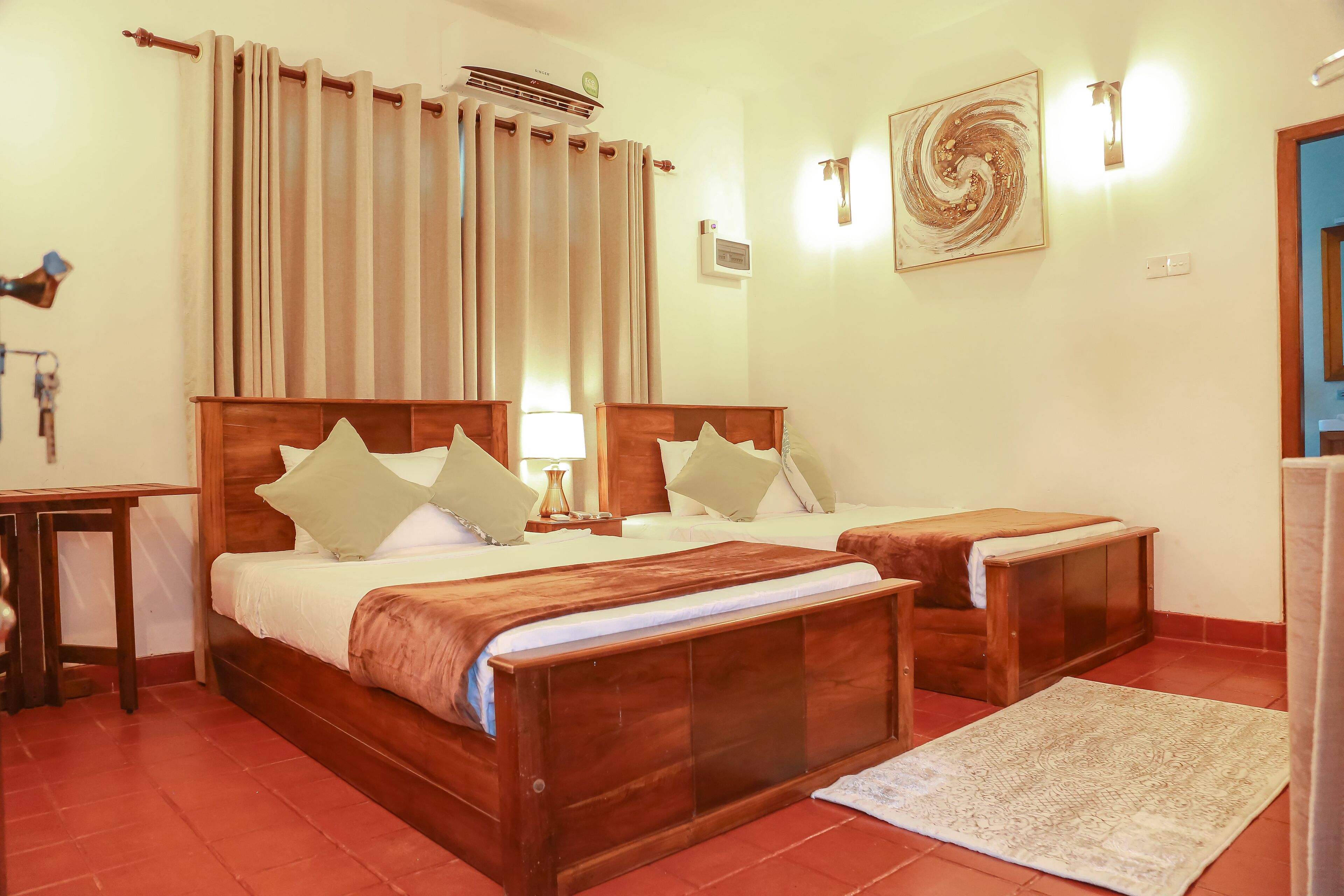 A double bed with a wooden headboard, a bedside table, and a nightstand with a lamp.