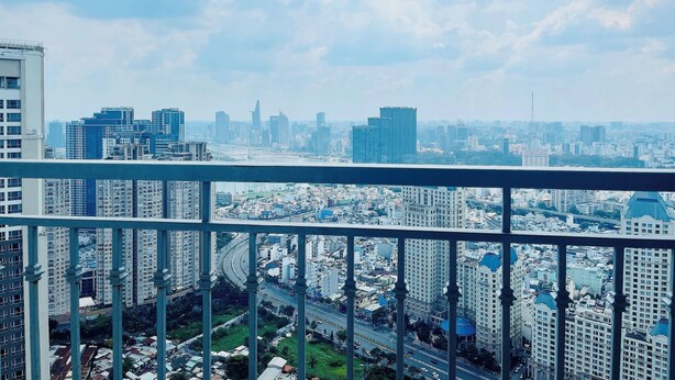 A cityscape with high-rise buildings, a bridge, and a clear sky. - Kelly House at Vinhomes Central Park (Ho Chi Minh City)