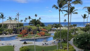 A resort with a pool area, palm trees, and a view of the ocean. - Ocean view room, Beachfront Kauai Beach Resort, Jacuzzis, 4 pools, restaurants (Lihue)