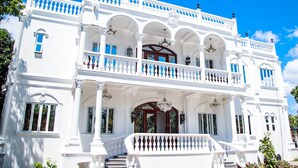 A white building with a balcony, columns, and a staircase. - Mancion Bakasyunan Resort San Pablo (San Pablo)