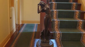 A staircase with ornate railings and a statue at the top. - Amazing 1934 deco house. (Wonthaggi,)
