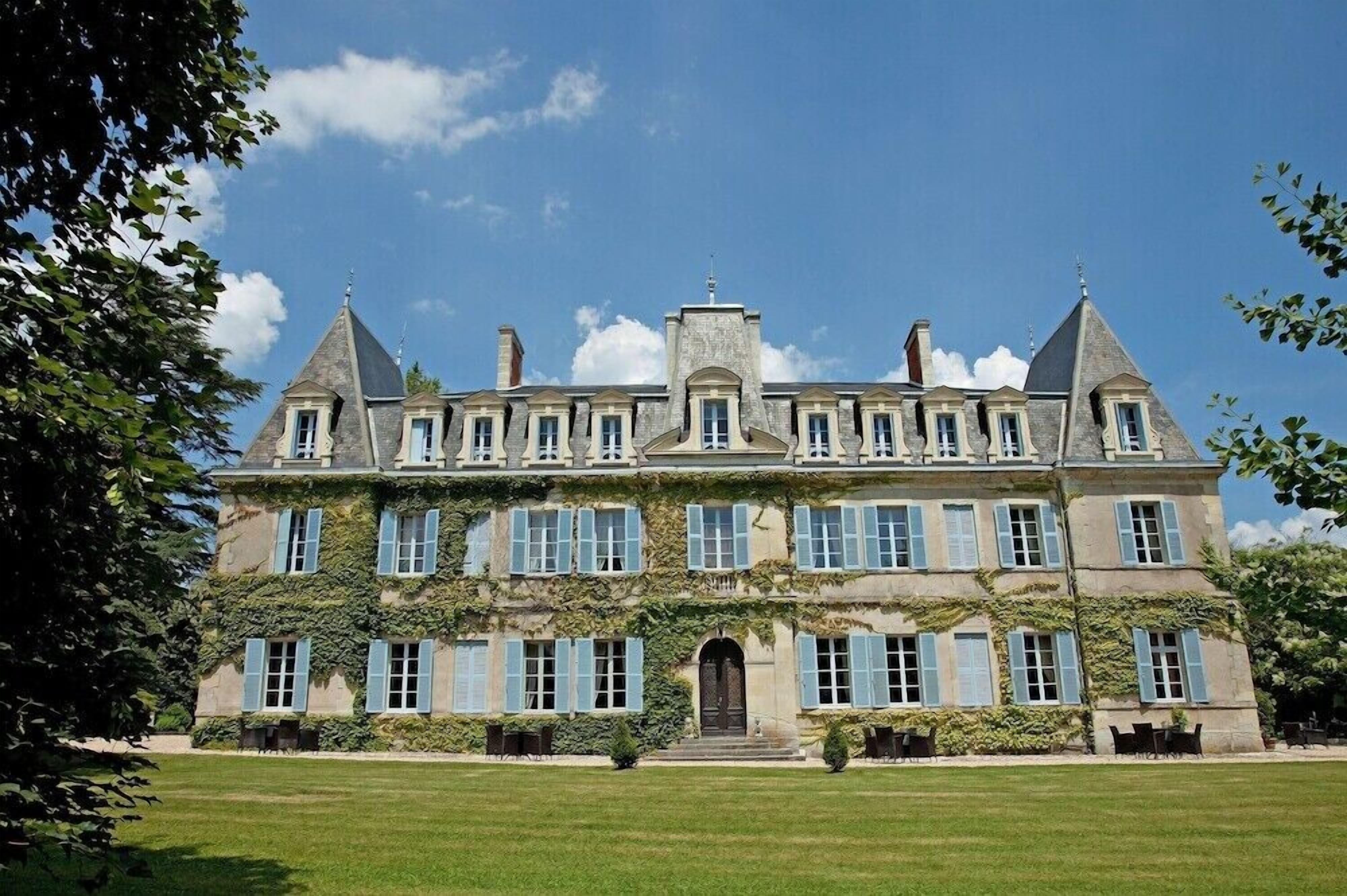 A large, historic building with multiple windows and a central entrance.