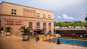 A building with a sign for 'CYTINASIUM' and 'SAUNA & SPA UNISEX SALON'. - Conference Hotel (Abeokuta)