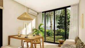 Un salón moderno con una mesa de comedor de madera, un banco, un sofá y un ventanal con vistas a zonas verdes.