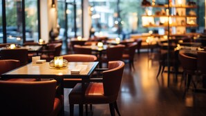 A restaurant with tables and chairs, large windows, and shelves with items. - Cloudy International Apartment (Guangzhou)