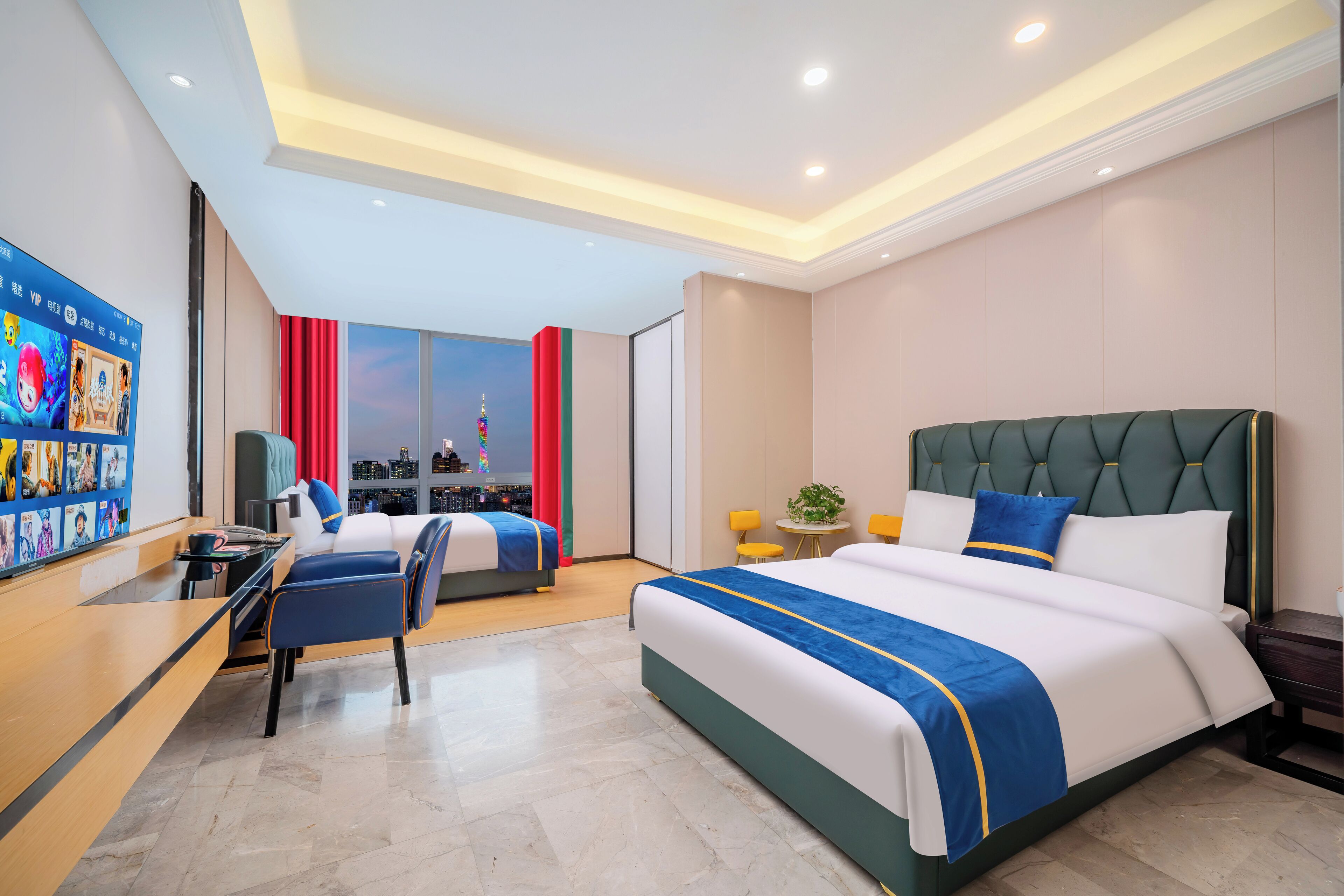 A modern hotel room with a large bed, a desk, and a seating area.
