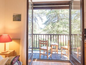 Relax on the deck with a comfortable bed and outdoor seating area.