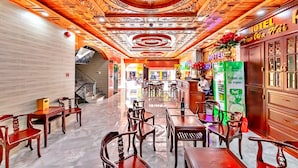 A hotel lobby with a polished marble floor, wooden furniture, and a decorative ceiling. - HANZ Cao Gia Hai Hotel (Ho Chi Minh City)