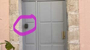 A gray door with a brass handle, a stone archway, and a number '8' sign above it. - Panoramic sea view of port and beaches (Bandol)