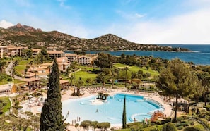 A resort with a large pool, multiple buildings, and a view of the sea and mountains. - A Relaxing Getaway with a Garden, Pools, and Parking - (Agay cap Estérel)