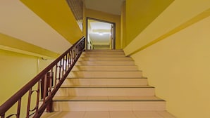 A staircase with a wooden handrail leading to an open doorway. - Hotel O Penginapan ReniNearMall Nagoya Hill (Batam)