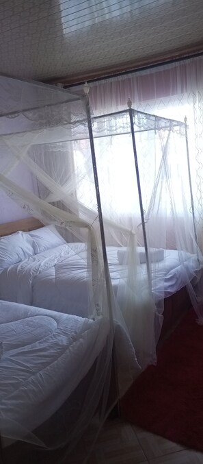 A room with a bed covered by a white canopy. - James's Shanzu Luxury Apartment (Mombasa)