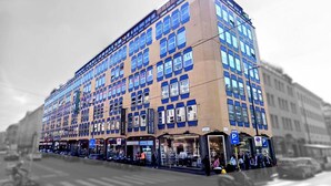 A multi-story building with numerous windows and storefronts on the ground level. - Hotel Vitruvio (Milan)