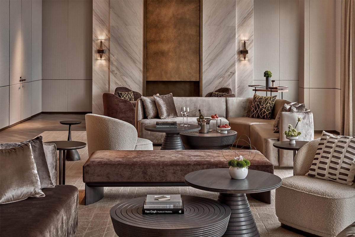 A modern living room with a sofa set, round coffee tables, and decorative pillows.