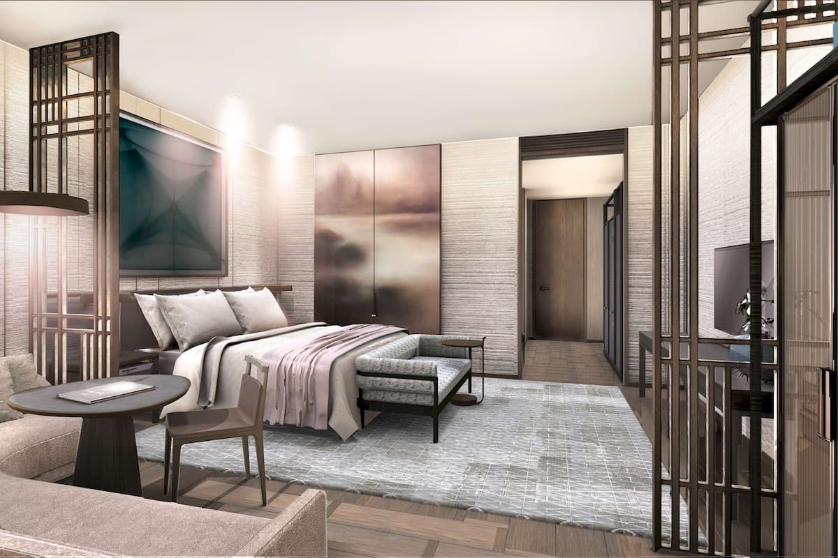 Un dormitorio moderno con cama, sofá y una mesita.