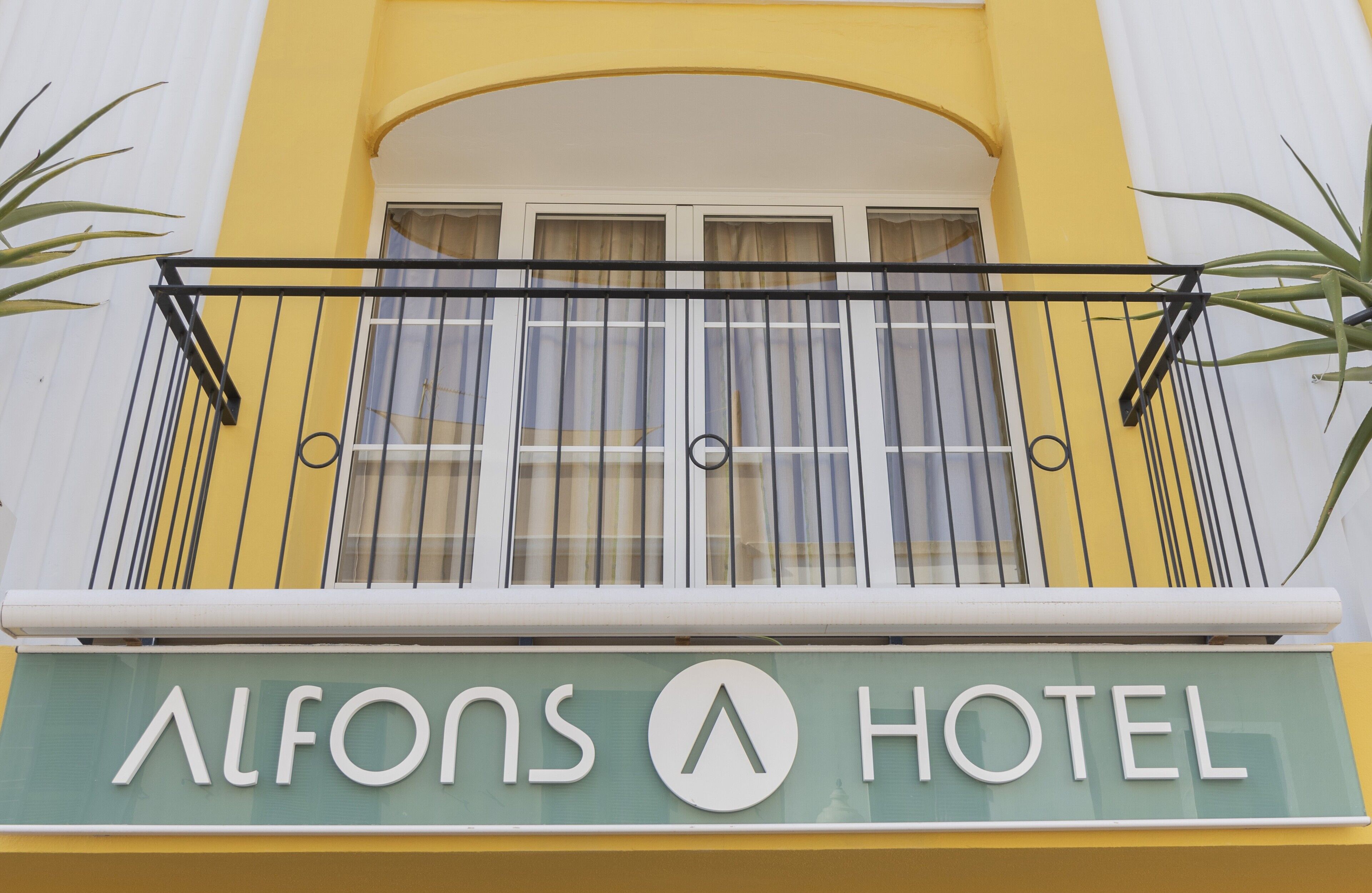 Un letrero de hotel con el nombre 'Alfons Hotel'.
