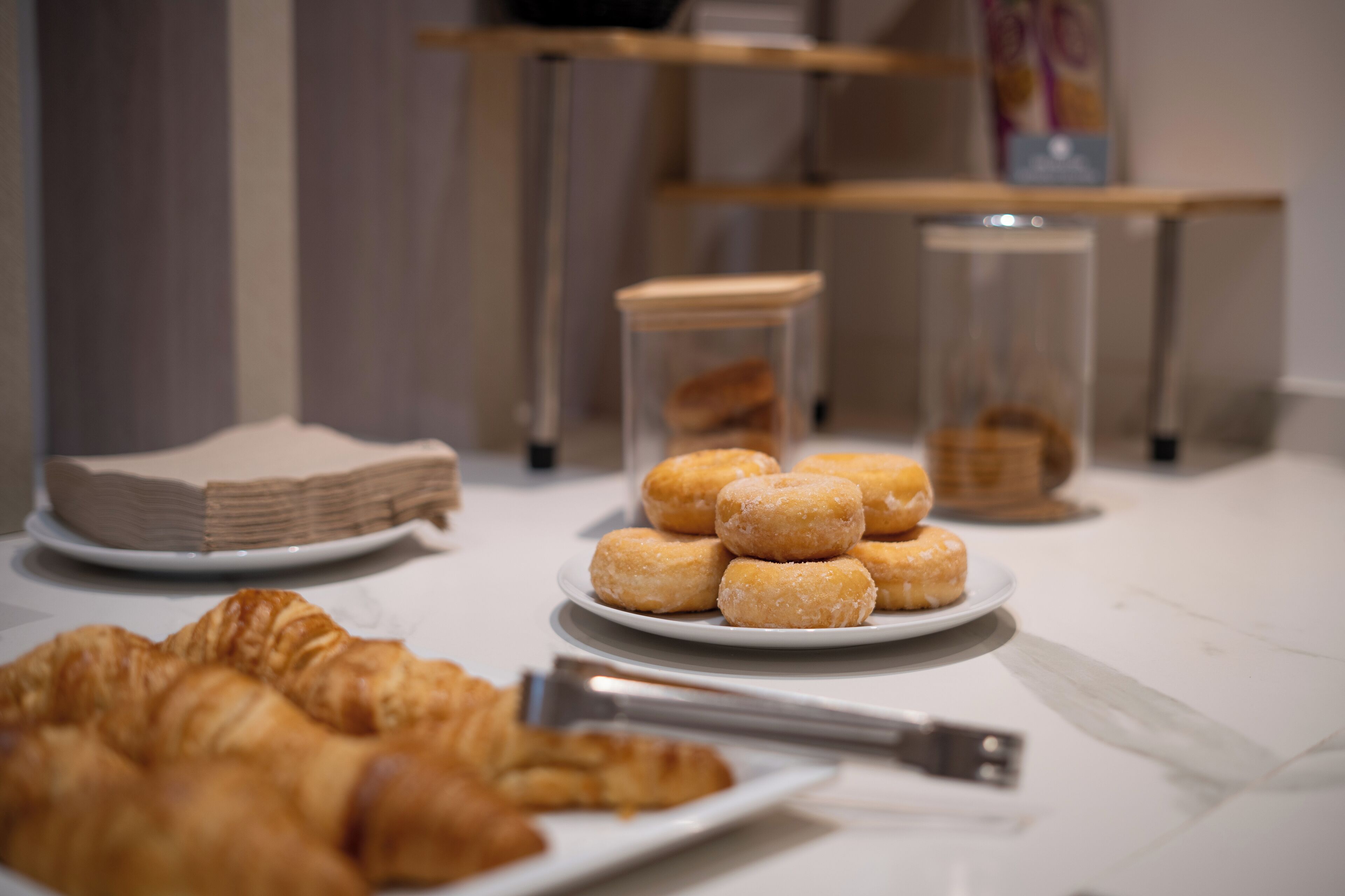 A table with pastries and a croissant.