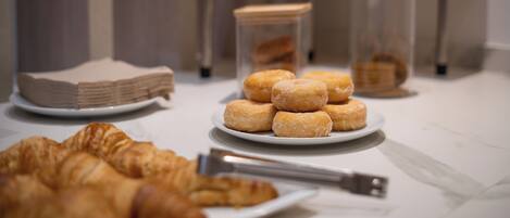 A table with pastries and a croissant.