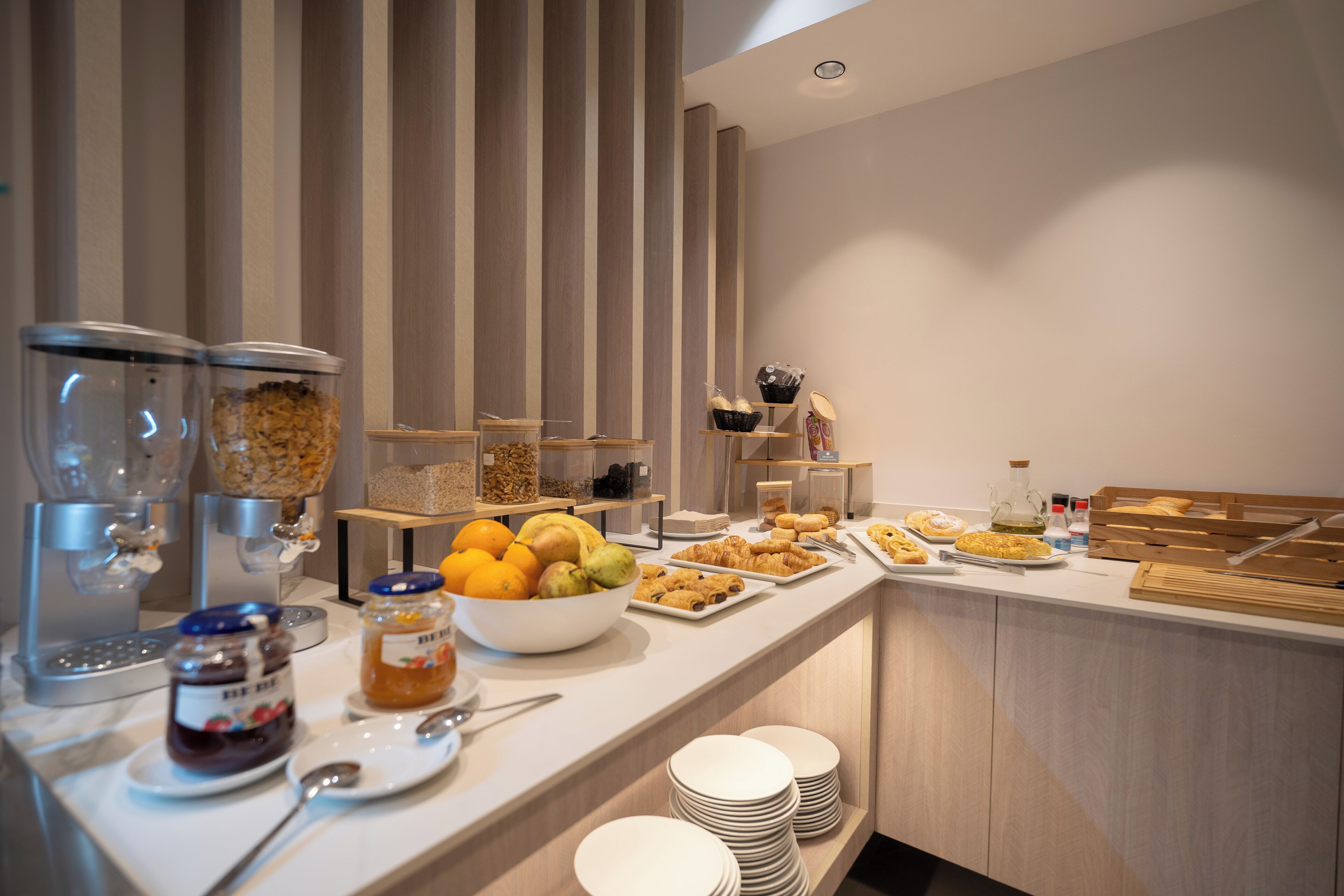A buffet setup with various food items and condiments.