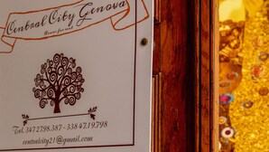 A sign for Central City Genova with contact information and a tree logo. - CENTRAL CITY (Genoa)