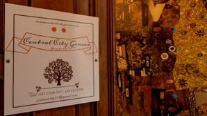 A sign for Central City Genova with contact information and a tree design. - CENTRAL CITY (Genoa)