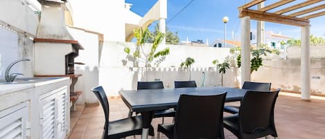 Enjoy al fresco dining on the patio, where a barbecue grill and dining table await.