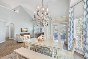 Enjoy meals in this elegant dining room with a large glass-top table and comfortable seating area.
