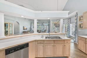 Enjoy cooking in this well-equipped kitchen with a central island, cabinetry, and a dishwasher.