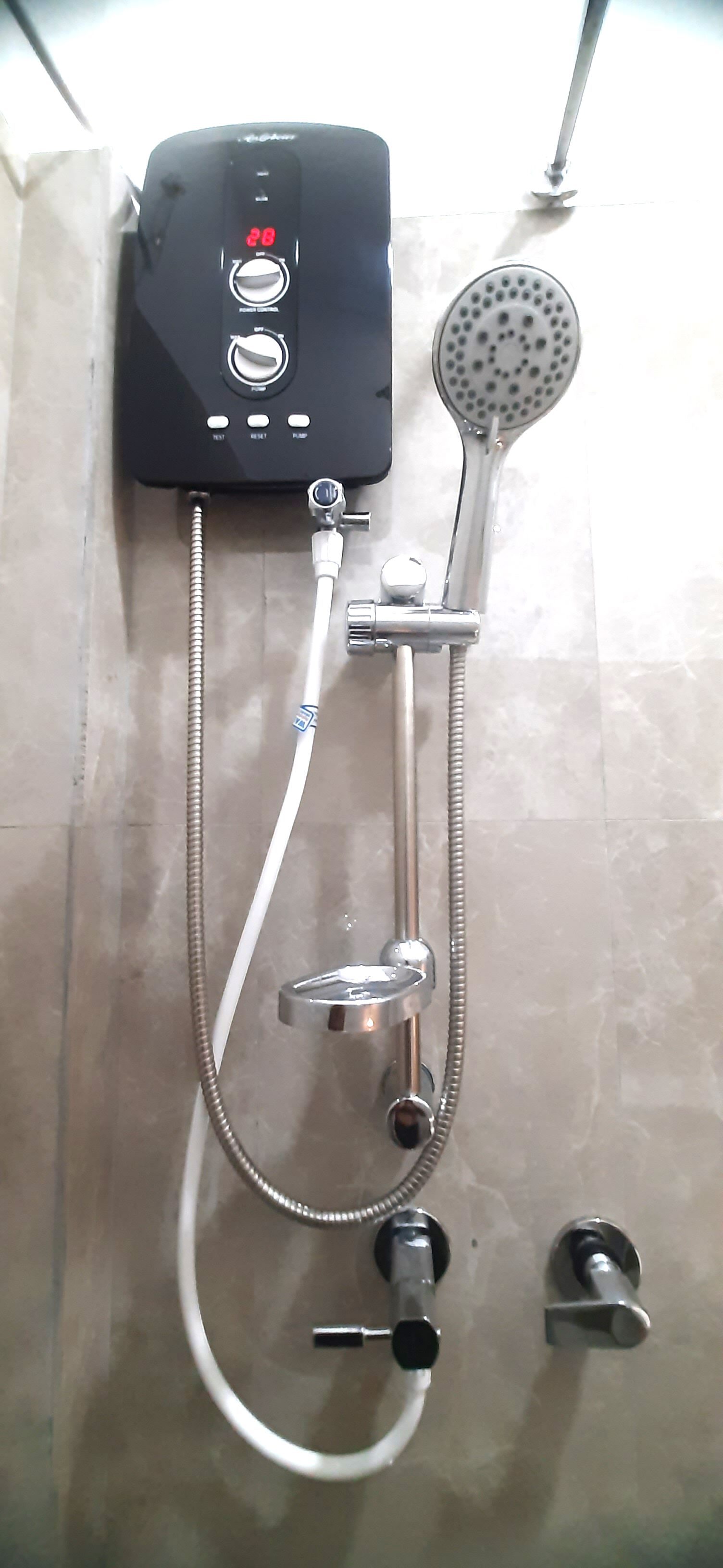 A shower unit with a digital display, multiple control knobs, and a handheld showerhead.
