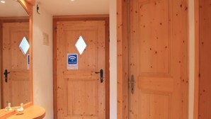 A wooden door with a sign indicating a free Wi-Fi zone. - Dauphin 7 by Interhome (Villars)