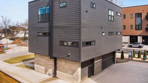 Een modern gebouw met twee verdiepingen, een plat dak, grote ramen en een fundering van baksteen.